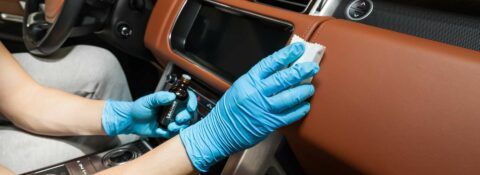 Surface protection specialist applying ceramic coating to interior of a BMW