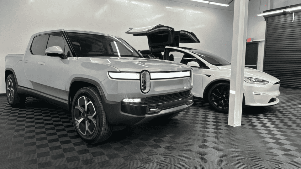 A Rivian R1T and Tesla Model S at Villar Auto Pros after getting surface protection installed