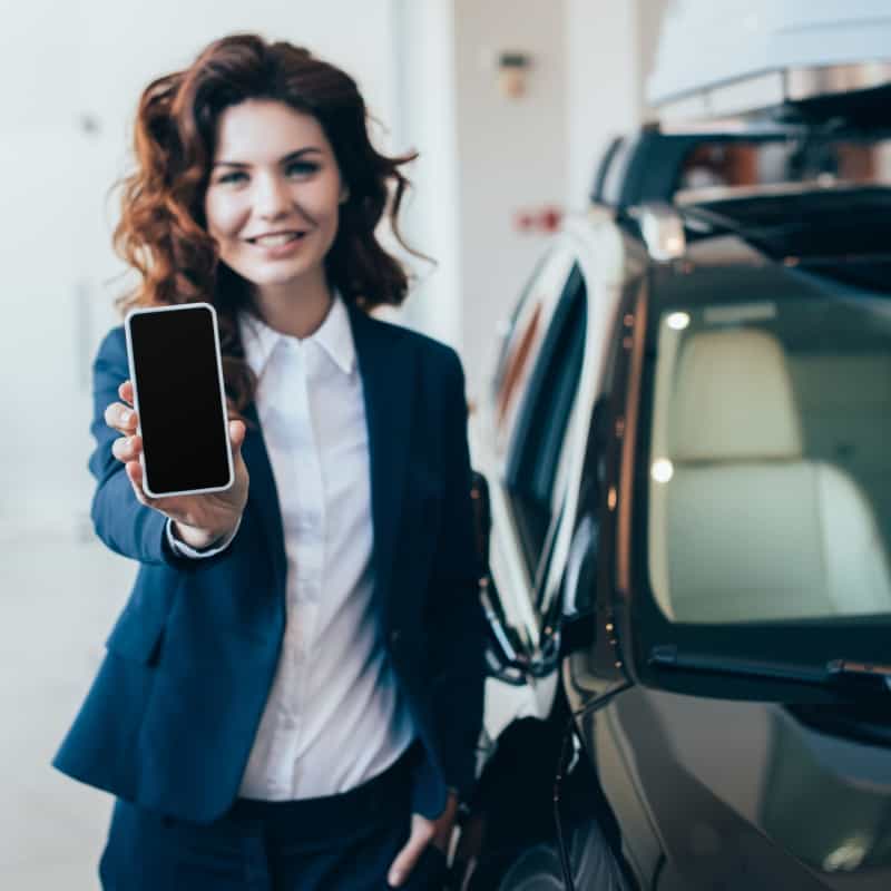 Sales associate looking at camera with phone