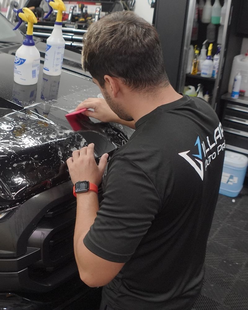 Professional Surface Protection Specialist from Villar Pros installing a Clear Bra Paint Protection Film on a Ford F-250 truck