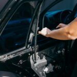 Professional technician replacing a side window on a vehicle